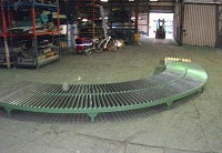 gravity roller bend for use with a conveyor system